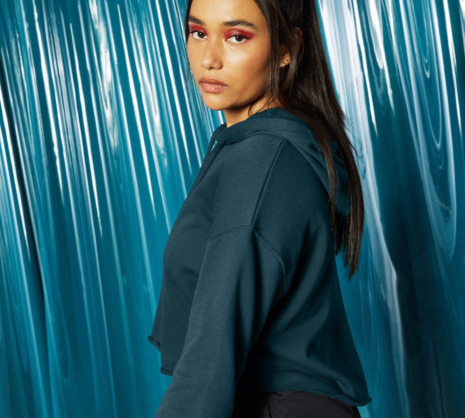 model wearing 7502 WOMEN'S CROPPED FLEECE HOODIE in atlantic
