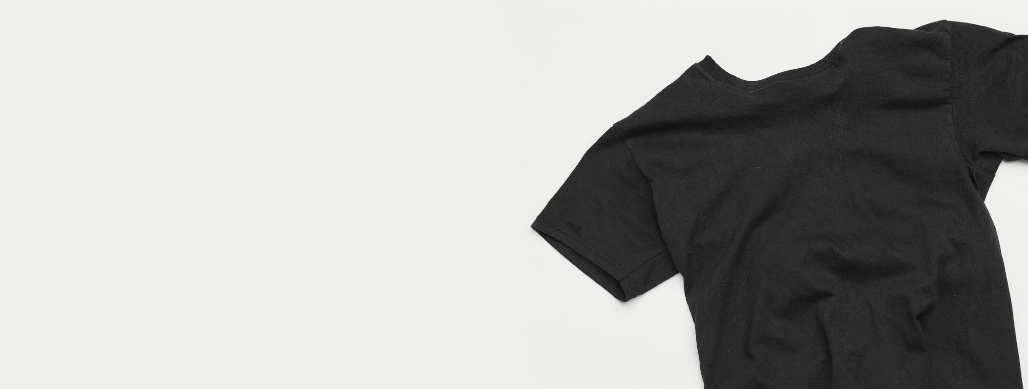 close up on black tee shirt laying flat on a table