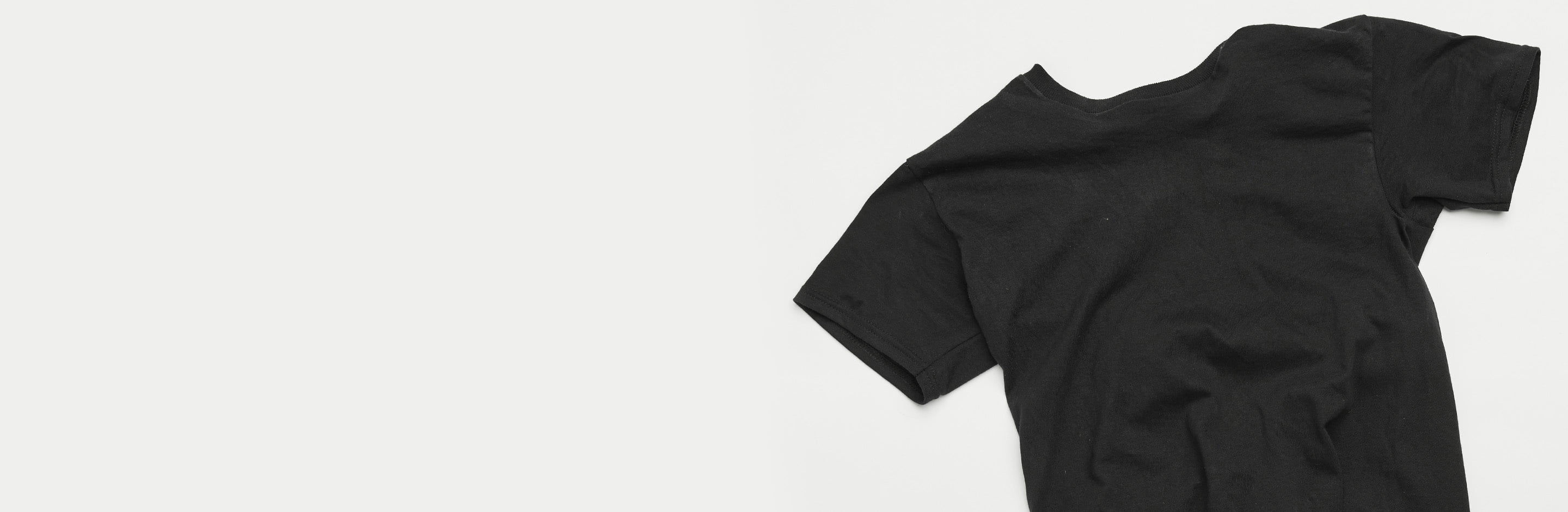 close up on black tee shirt laying flat on a table