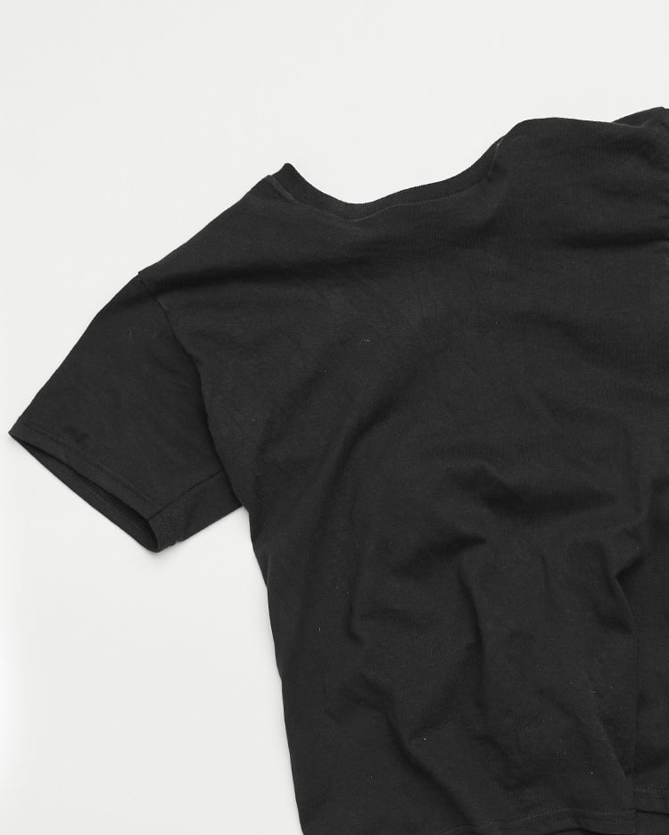 close up on black tee shirt laying flat on a table