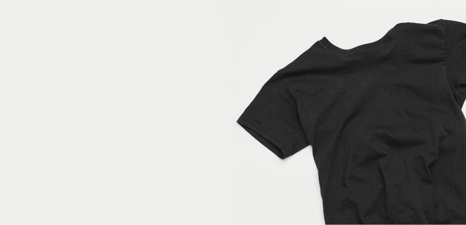 close up on black tee shirt laying flat on a table