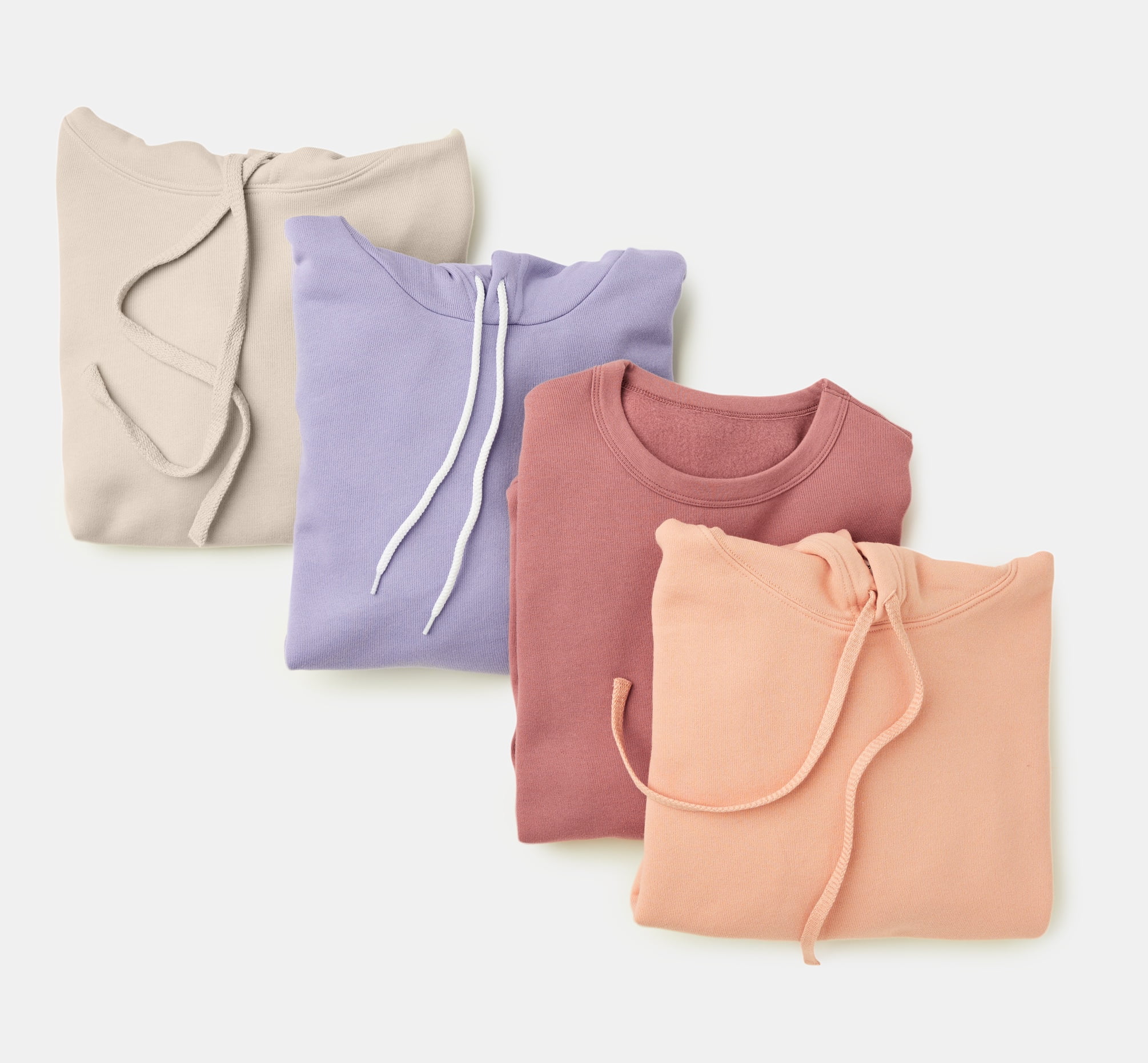 top down shot of four staggered, folded sponge fleece sweatshits of different colors